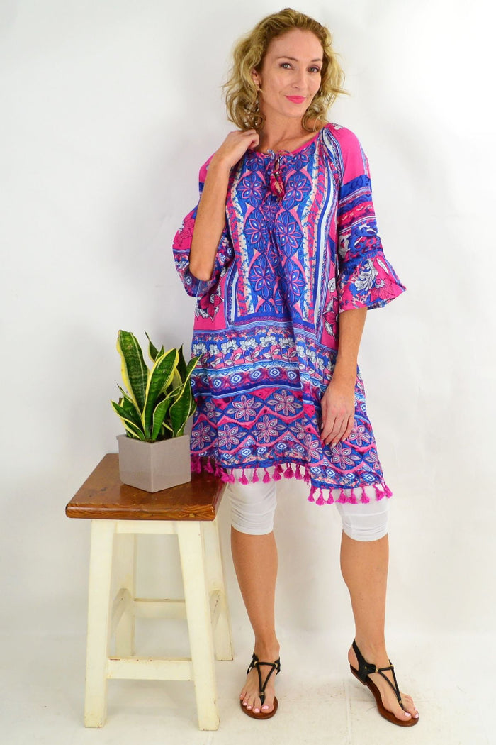 Blue St Tropez 3/4 sleeve tunic dress by Orientique, featuring a relaxed fit and lightweight fabric, displayed on a hanger.