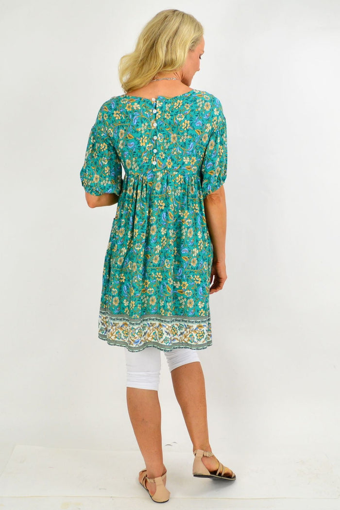 Emerald green puff sleeve tunic dress by Indigo Designs with floral pattern, knee-length, and relaxed fit.