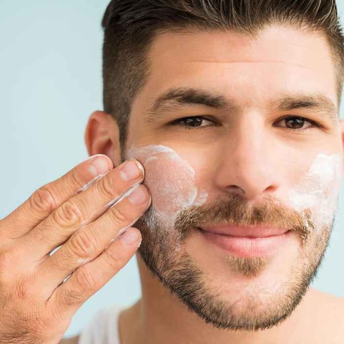 white man brown hair and beard applying best oil free moisturizer to face. dermal essentials medical grade skincare.