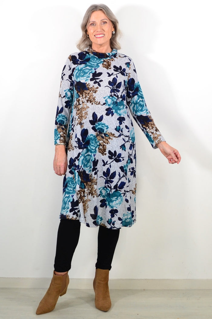 Long green floral winter tunic by La Mode featuring a roll neck and long sleeves, displayed on a hanger.