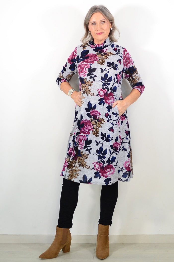 Long pink floral winter tunic from La Mode, featuring a roll neck and elegant floral pattern, suitable for cold weather wear.