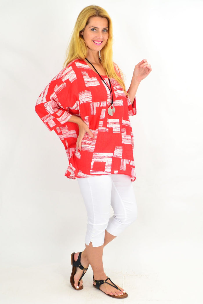 Orange-red and white block tunic top by Missy Q, featuring a stylish, casual design with long sleeves and a relaxed fit.