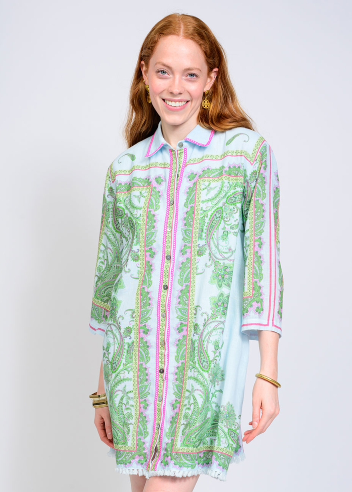 Woman wearing a blue, pink, and green button down collared mini dress