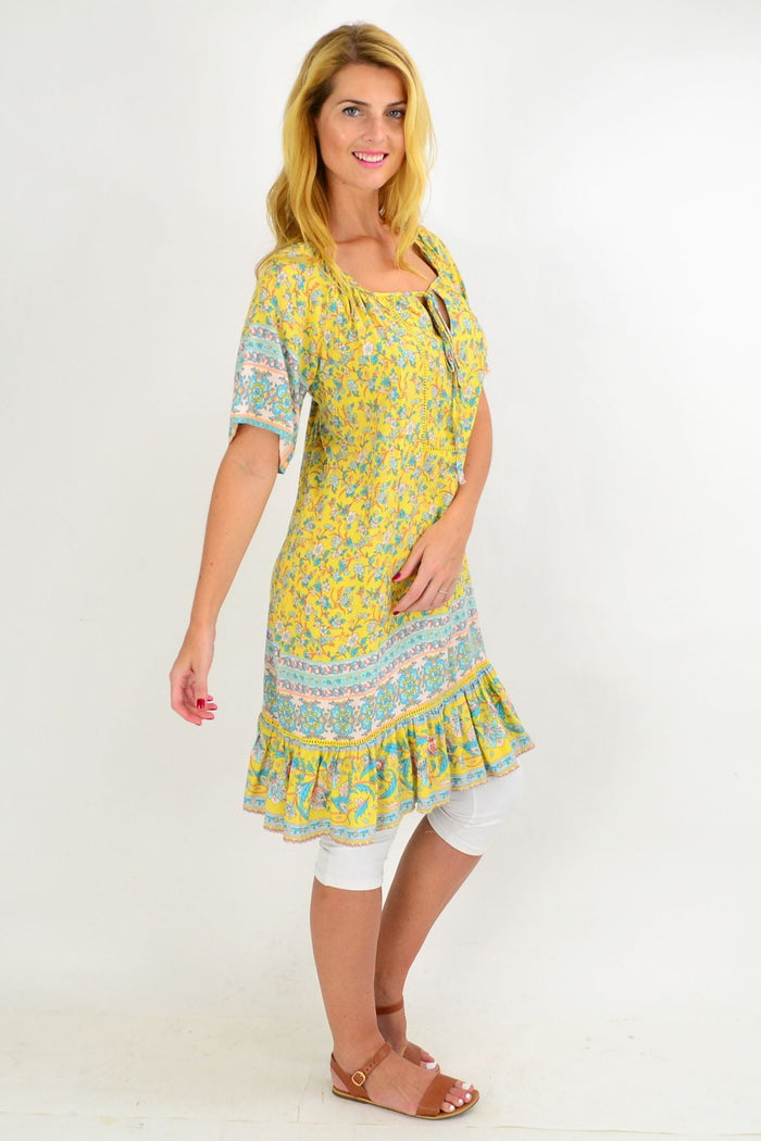 Yellow floral flowy tunic top from New U Collection featuring lightweight fabric and a relaxed fit with vibrant floral pattern.