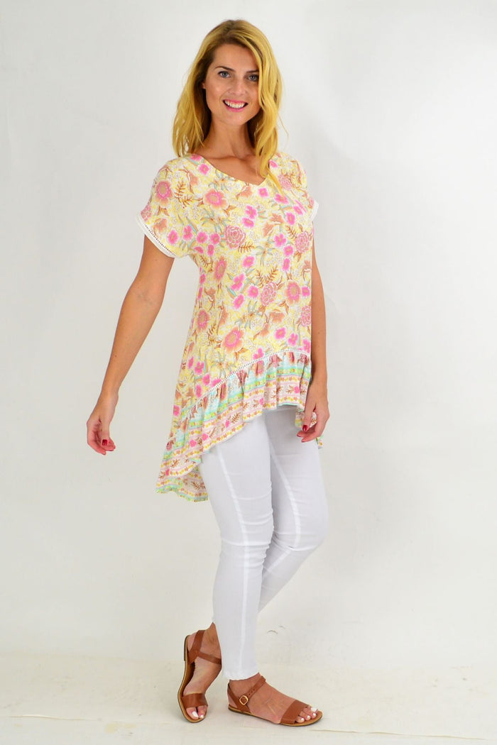 Pink and yellow floral hi-low tunic top from New U Collection featuring a flowy, feminine design with a floral pattern.