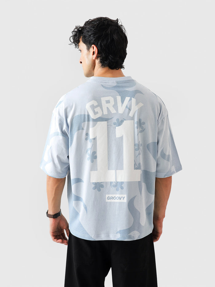 Allover GRVY frost blue tee male model back view allover GRVY pattern Pakistan – GROOVY