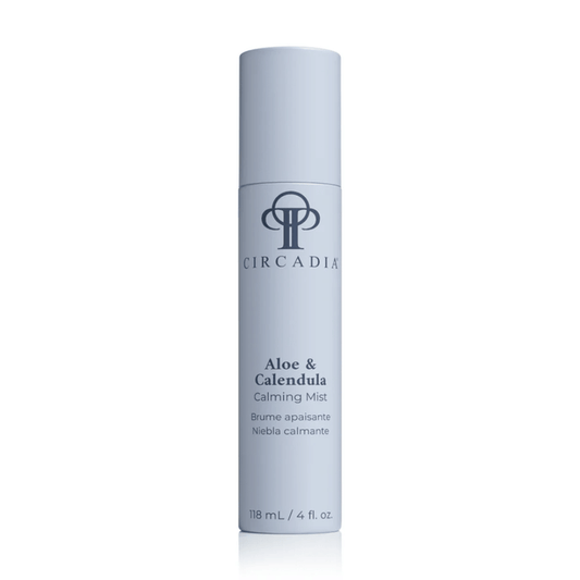 A sleek white bottle of Aloe & Calendula Calming Mist | Circadia, a skincare product designed to soothe and refresh the skin, standing upright against a plain background.