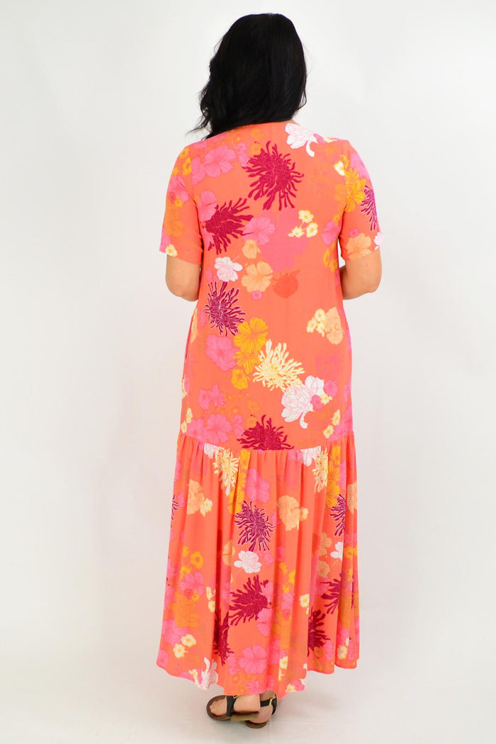 Apricot floral maxi tunic dress from New U Collection, flowing fabric with vibrant floral pattern, sleeveless design, and relaxed fit.