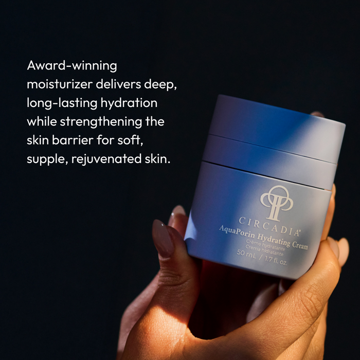 Hand holding a jar of AquaPorin Hydrating Cream | Circadia against a dark background with text describing its deep hydration and skin barrier strengthening benefits for soft, supple skin.