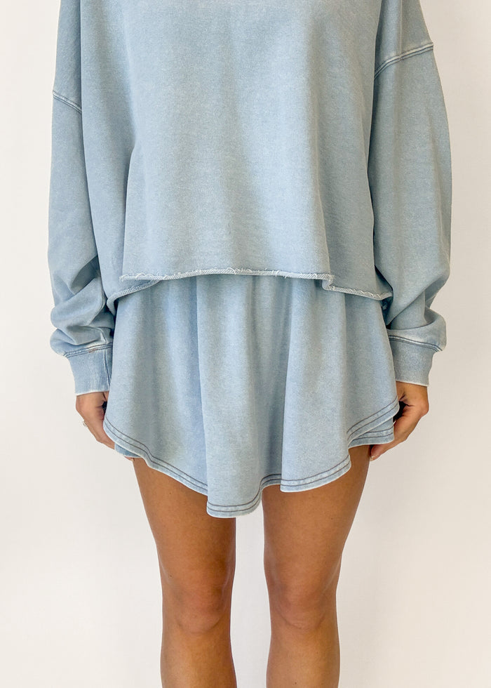Light blue oversized sweatshirt and shorts set on a plain background