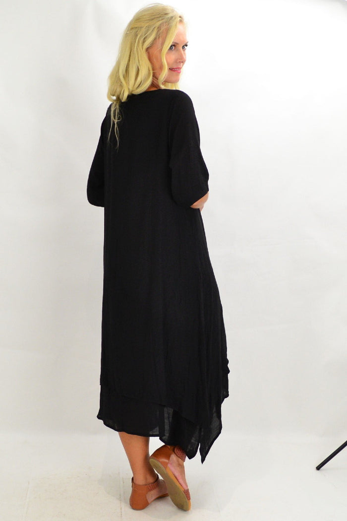 Black coconut overlay tunic dress by La Mode, featuring flowy fabric and stylish design, displayed on a hanger.