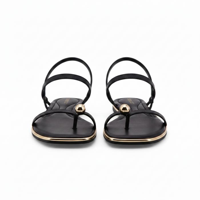 Black Sandals featuring a delicate gold toe ring
