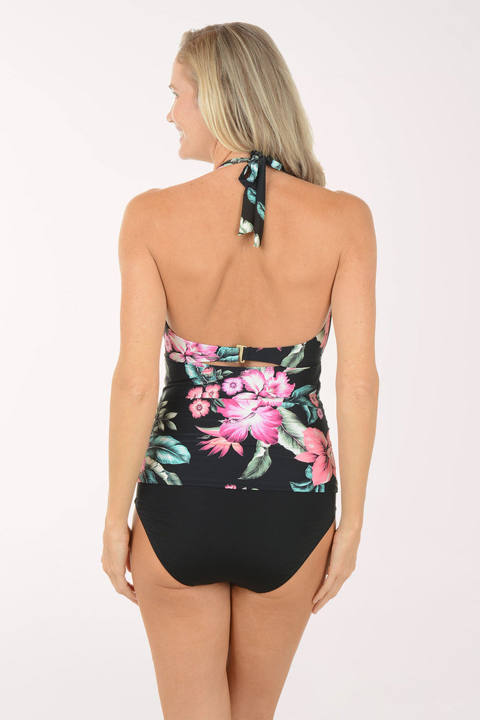 Woman wearing a floral tankini top on a white background