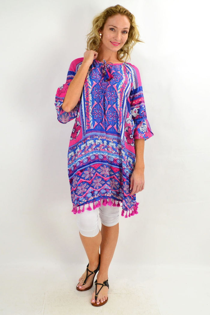 Blue St Tropez 3/4 sleeve tunic dress by Orientique, featuring flowing fabric and a relaxed fit, shown on a hanger.