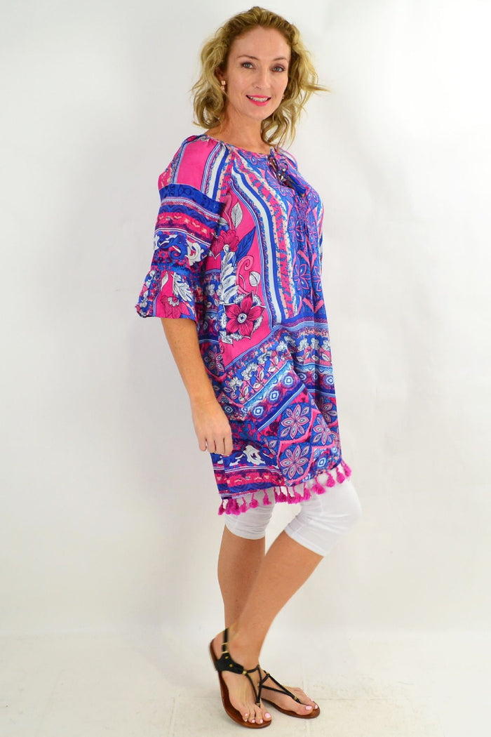 Blue St Tropez 3/4 sleeve tunic dress by Orientique, featuring a relaxed fit and vibrant print, displayed on a hanger.