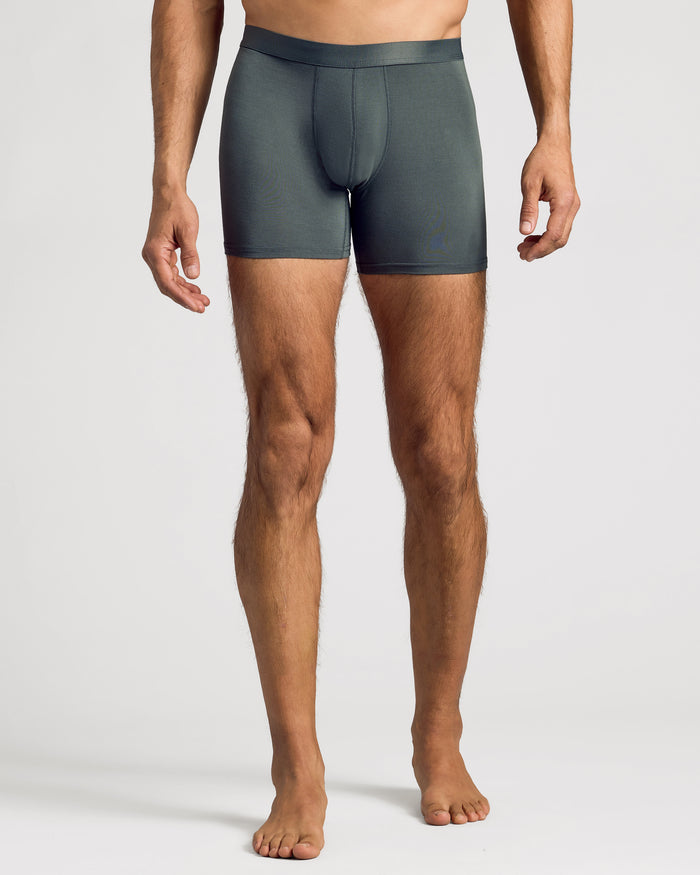 Man wearing Carbon Boxer Brief, showcasing snug fit and mid-thigh length.