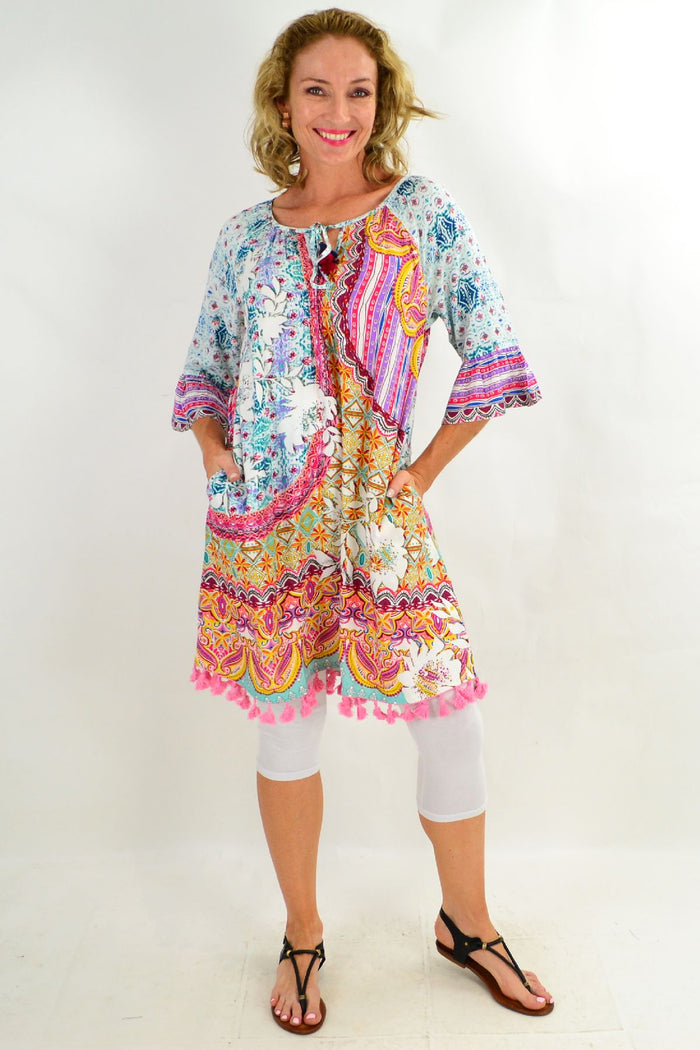 Orientique Chateau 3/4 sleeve tunic dress displayed on a hanger with a relaxed fit and stylish design.