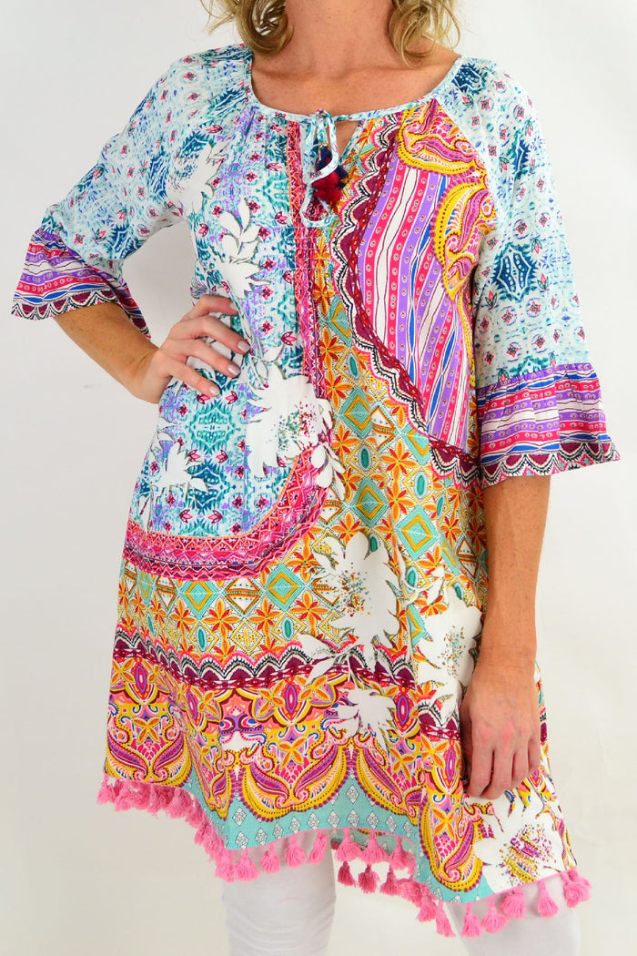 Orientique Chateau 3/4 sleeve tunic dress hanging on a hanger, showcasing its relaxed fit and lightweight fabric.