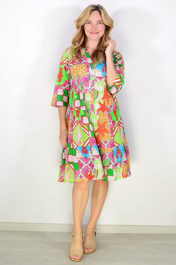 One Summer Coastal Vacation Beth tunic dress with relaxed fit, featuring breezy fabric and beach-inspired design, displayed on a hanger.
