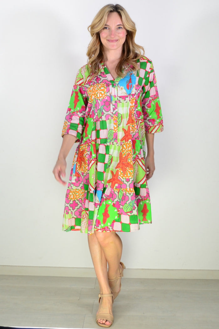 One Summer Coastal Vacation Beth Tunic Dress displayed on a hanger with a beach-inspired pattern and lightweight fabric.