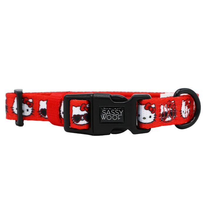 The Sassy Woof Dog Collar - Hello Kitty® Red Classic features an adjustable fit, a black plastic buckle, and a repeating Hello Kitty with sunglasses design—ideal for Sanrio fans who want stylish accessories for their pets.