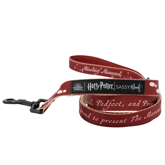 The Sassy Woof Dog Leash - Harry Potter™ Marauder's Map™ features a maroon design with white paw prints, branded logos, Marauder's Map text, a padded neoprene handle, and a black metal clasp for secure collar attachment.