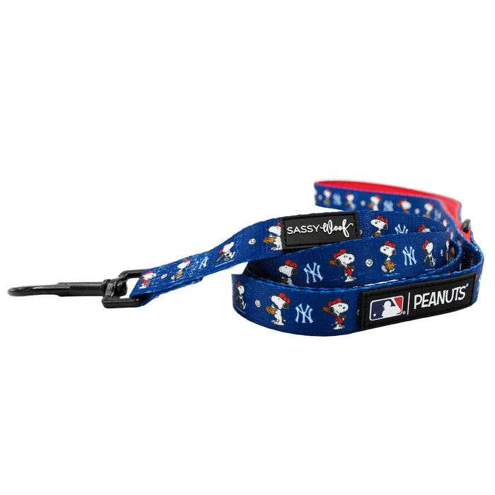 The Sassy Woof Dog Two Piece Bundle - MLB™ x Peanuts™ New York Yankees™ features a blue Snoopy dog leash with team logos and a sturdy metal clasp, perfect for pairing with the matching harness.