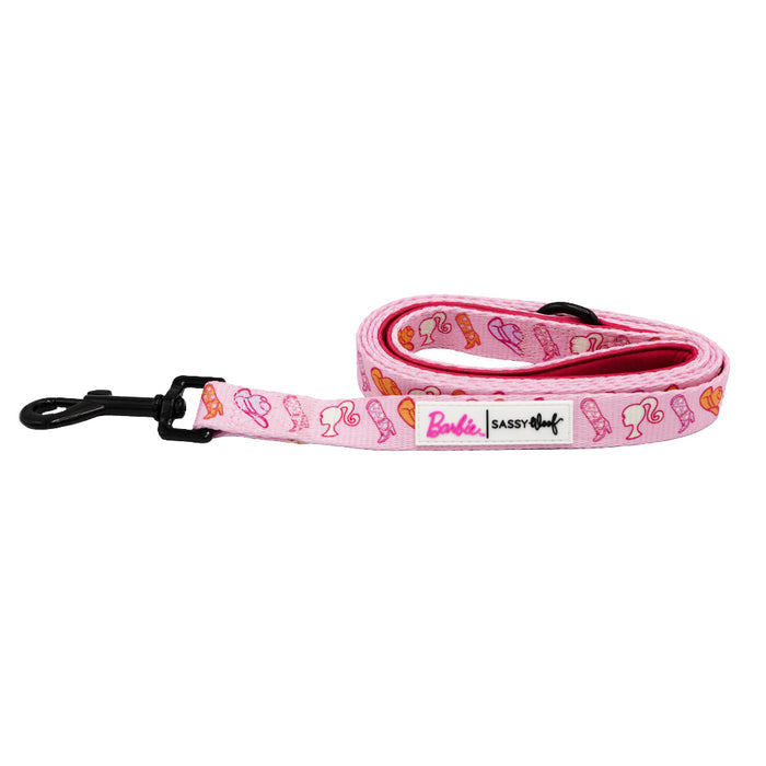 The Dog Leash - Western Barbie™ by Sassy Woof features the Barbie logo and label, playful icons like shoes and sunglasses, a sturdy metal clip, and vibrant pink-orange hues for a fun, stylish walk.