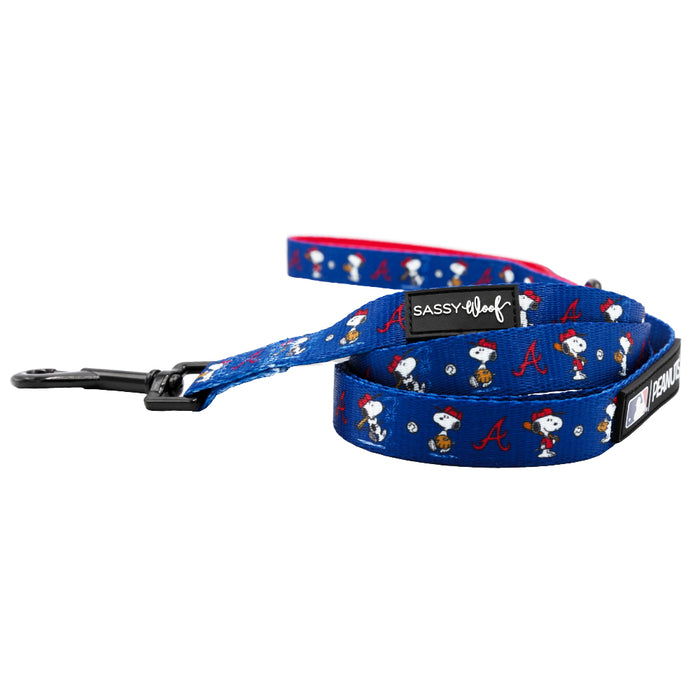 The Sassy Woof Harness Three Piece Bundle - MLB™ x Peanuts™ Atlanta Braves™ features Snoopy, Woodstock, red Braves A logos, and MLB tags—perfect to pair for fans looking to outfit their dog in team spirit.