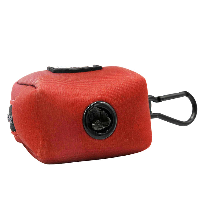 The Sassy Woof Dog Waste Bag Holder - Burgundy is a rectangular neoprene pouch with a black plastic dispenser and carabiner, ideal for walks and perfectly complementing your matching dog harness set.