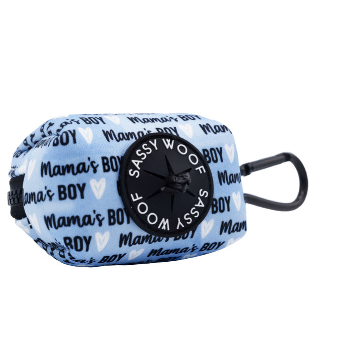 The Sassy Woof Dog Waste Bag Holder - Mama's Boy features a blue and white design with "Mamas BOY" text, small hearts, a black dispenser, and carabiner for easy attachment. From the Mama's Boy collection.