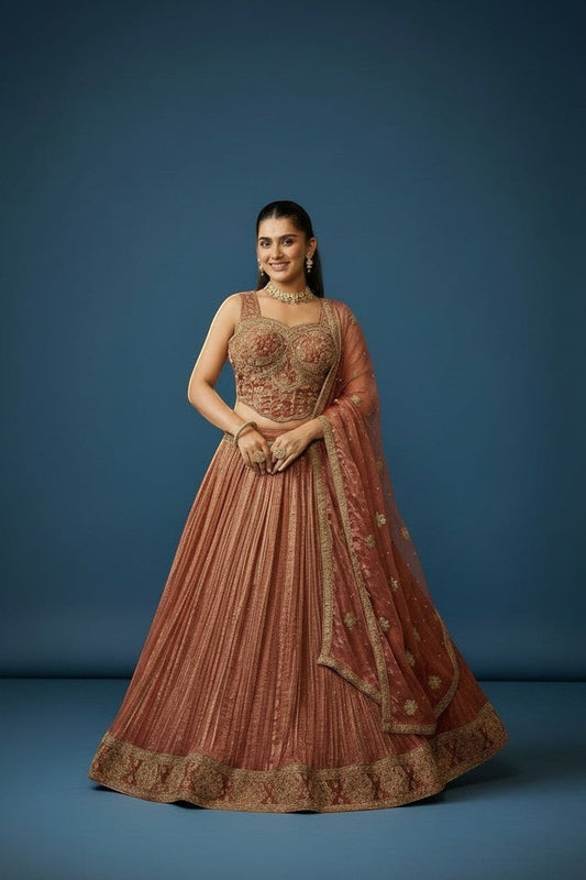 Kurti Connection USA woman in embroidered rose gold lehenga set with intricate gold detailing and matching dupatta.