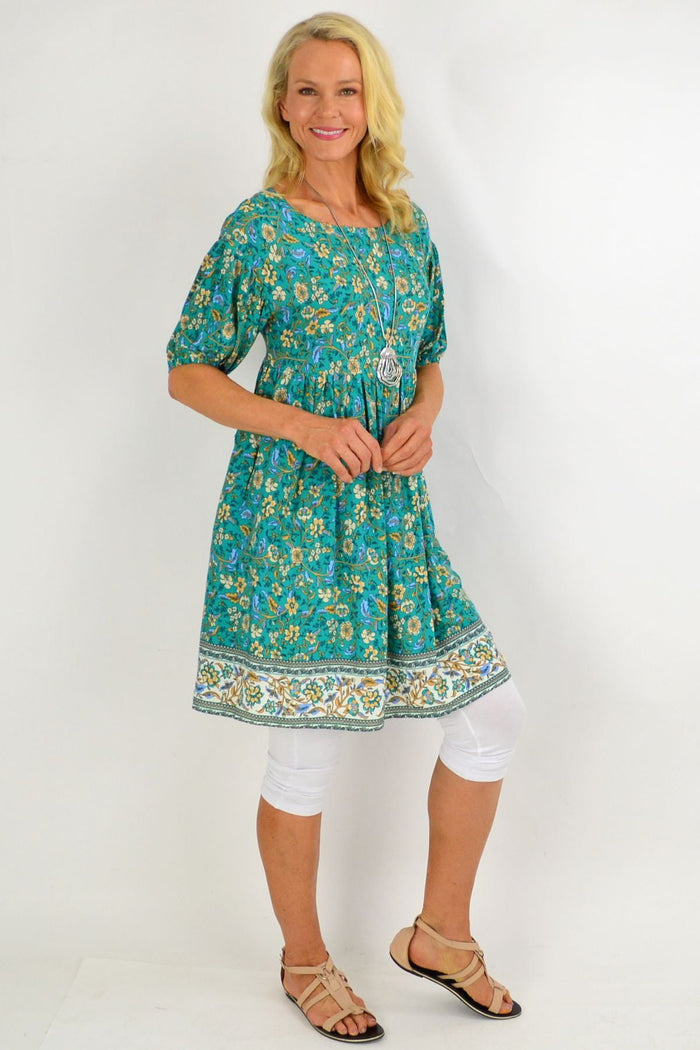 Emerald green puff sleeve tunic dress from Indigo Designs, featuring a flowy silhouette and stylish puff sleeves.