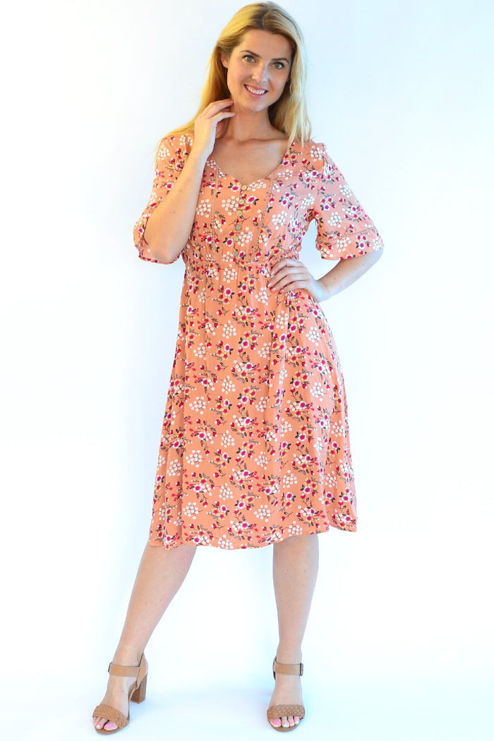 Dull orange Zen Garden Field of Flowers tunic dress with floral pattern, lightweight fabric, and relaxed fit.