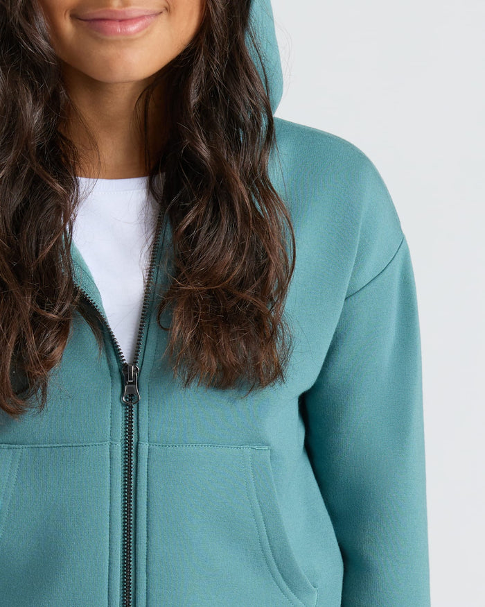 Model in Girls Stormcloud Cropped Zip Hoodie, showing kangaroo pocket and zipper.