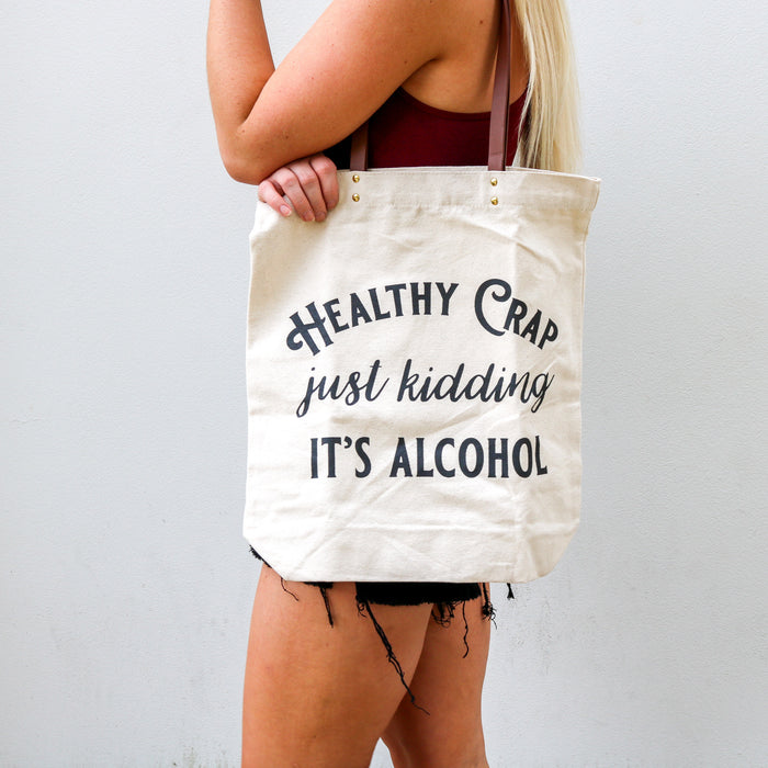 Woman holding Healthy Crap alcohol tote bag
