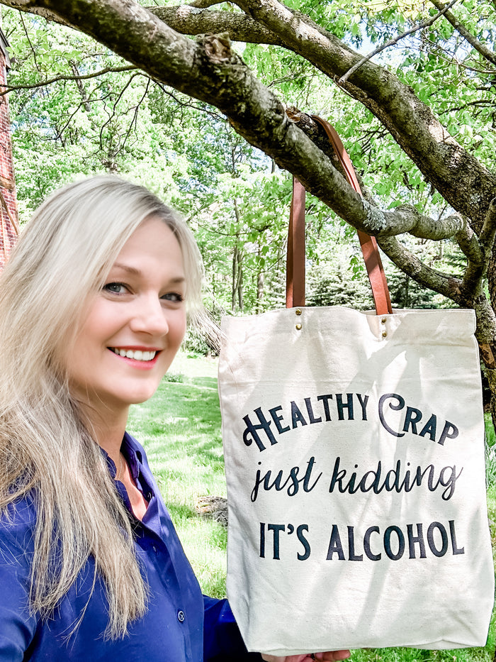 Woman holding Healthy Crap alcohol tote bag, Facetune 15-05-2023