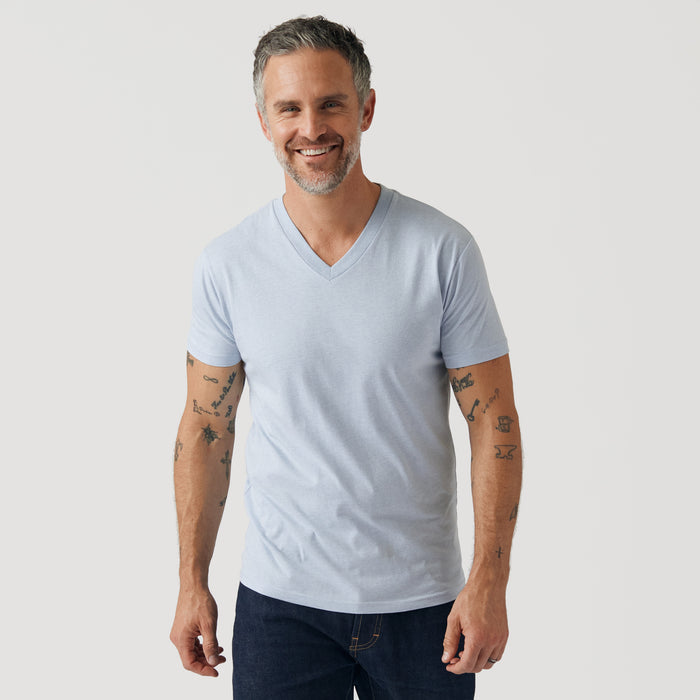 Man wearing Heather Pale Blue V Neck T Shirt and dark jeans.