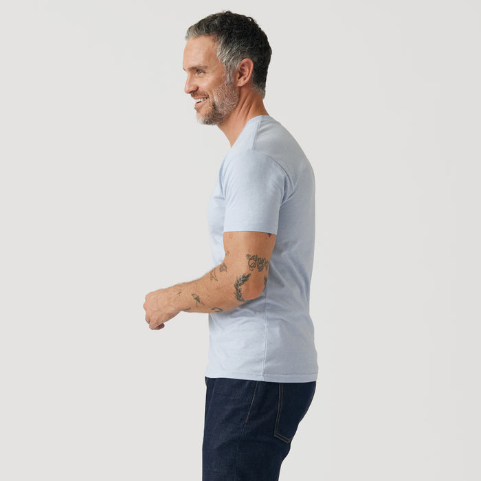Man in Heather Pale Blue V Neck T Shirt, side view.