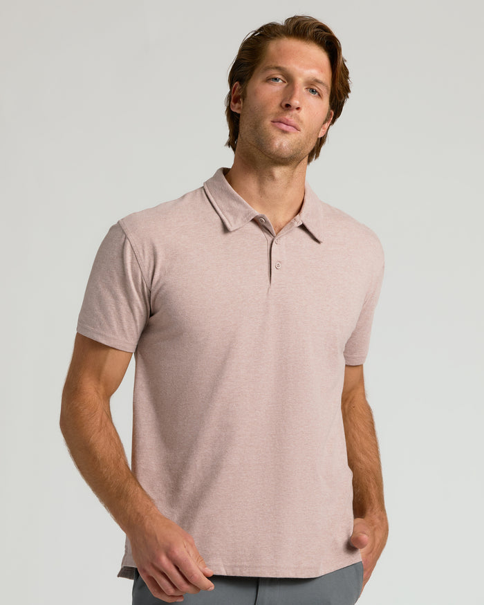 Young man in Light Heather Slate Mauve Classic Polo and neutral pants.
