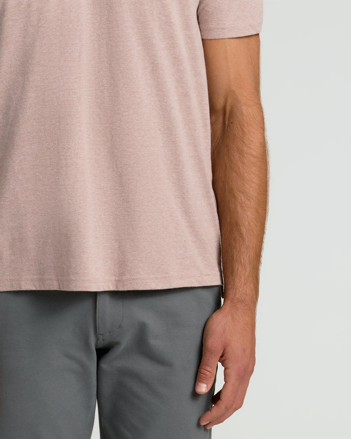 Person wearing Light Heather Slate Mauve Classic Polo, showing right arm and relaxed fit.