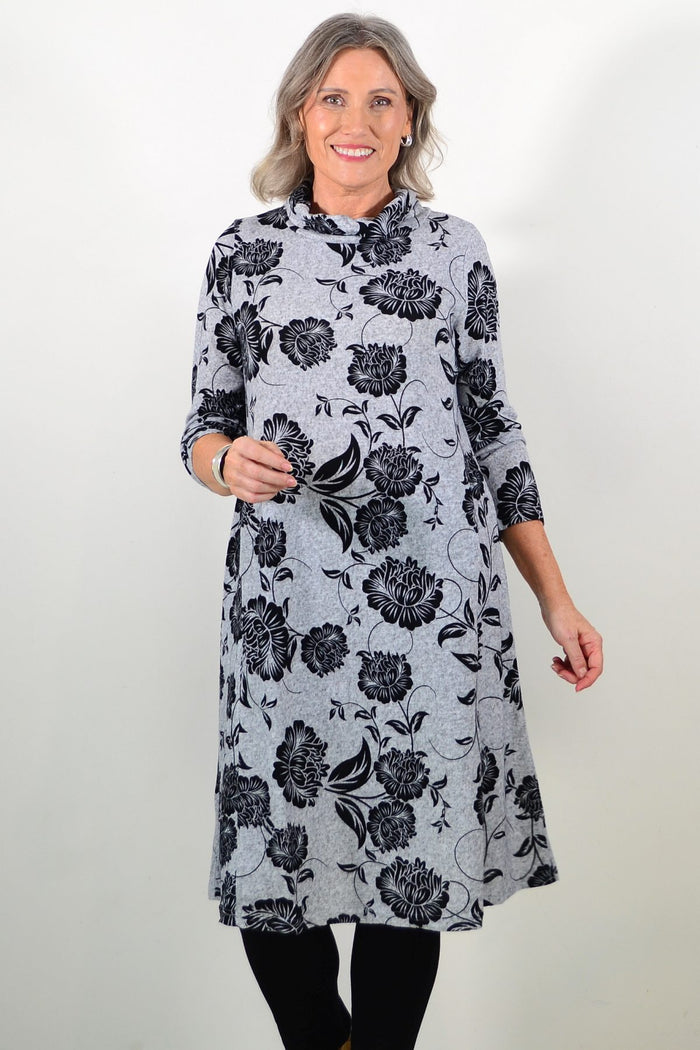 Long black floral winter tunic with roll neck design by La Mode, featuring a flowing fit and floral pattern.
