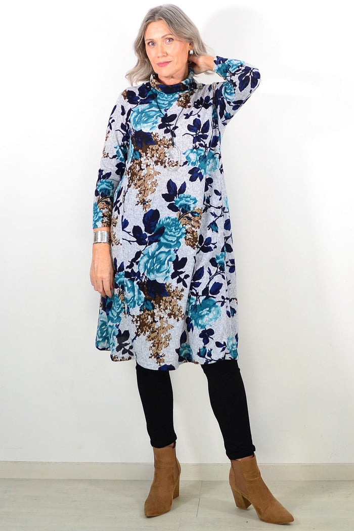 Long green floral winter tunic with roll neck, La Mode brand, featuring a cozy, floral-patterned design and comfortable fit.