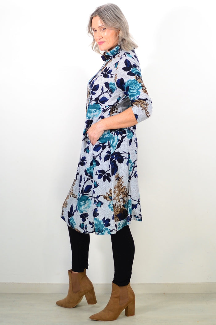 Long green floral winter tunic with roll neck from La Mode, featuring a cozy, floral design and flowing fabric.