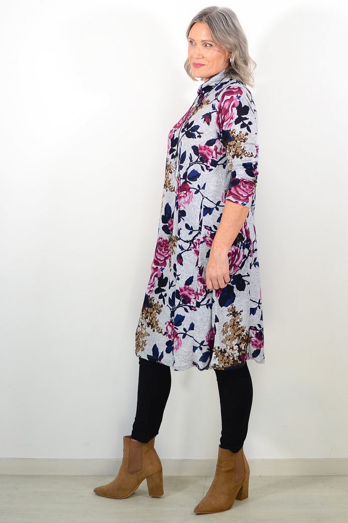 Long pink floral La Mode winter tunic with roll neck and floral pattern, shown on a hanger.