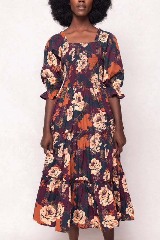 Woman wearing a floral dress with a white background