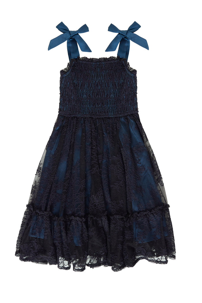 Navy blue dress with bow straps on a white background