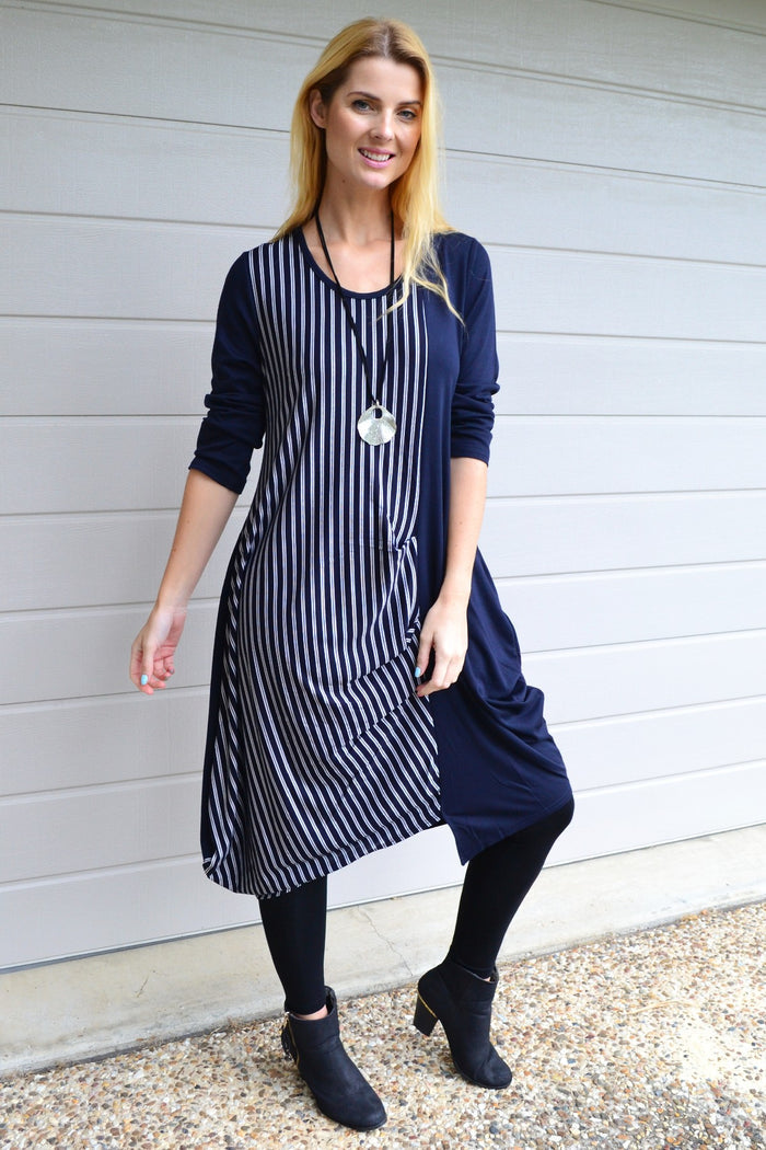 Navy 3/4 sleeve stripe jersey tunic dress by Whispers, featuring a relaxed fit and horizontal stripe pattern, hanging on a hanger.