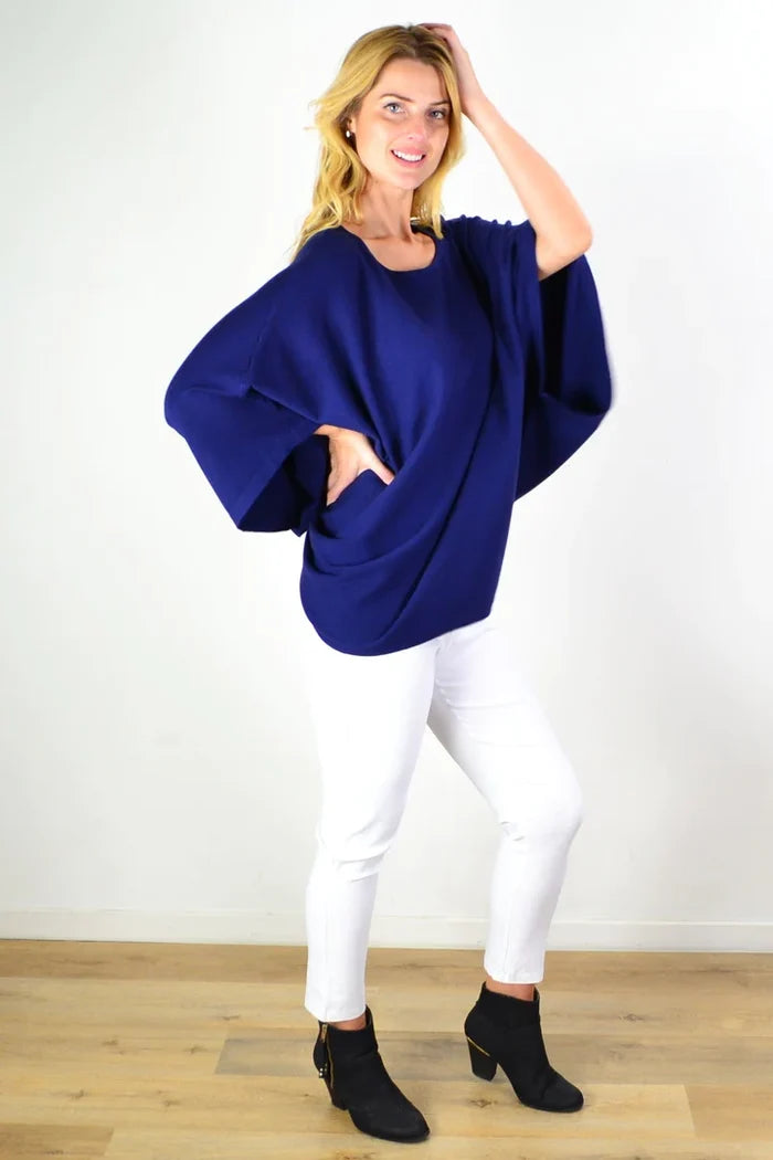 Navy blue rounded tunic poncho from Cali&Co featuring a loose fit and soft fabric, displayed on a mannequin.
