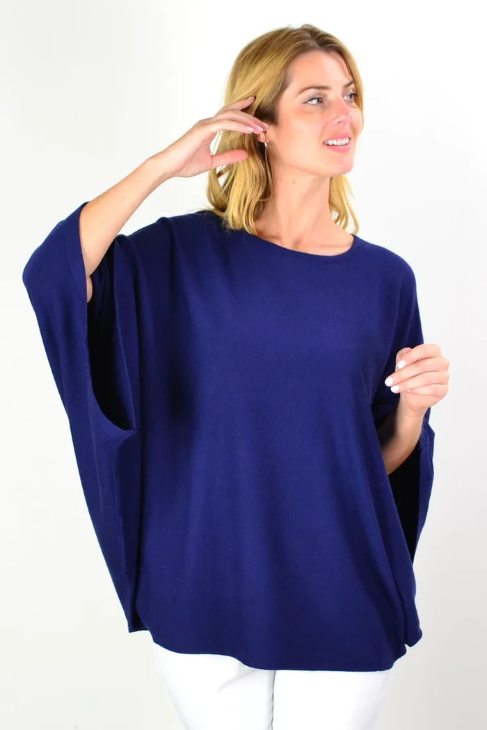 Navy blue rounded tunic poncho by Cali&Co, featuring a loose fit and soft fabric, displayed on a hanger against a white background.